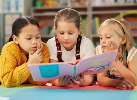 depositphotos_725399962-stock-photo-children-book-reading-together-school